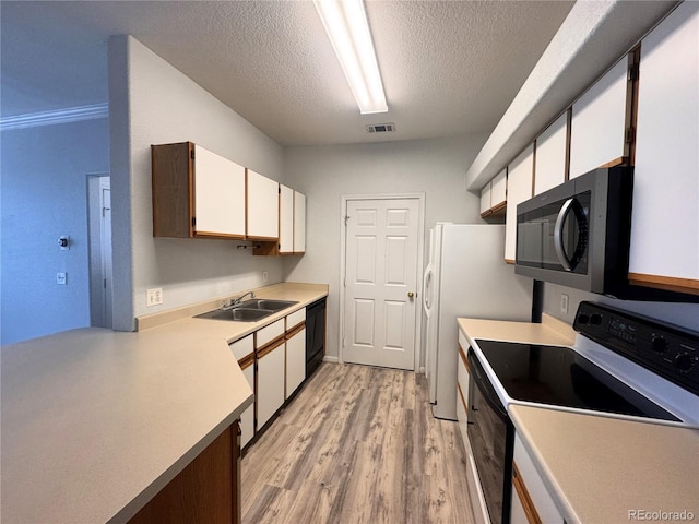 kitchen with visible vents, range with electric stovetop, black dishwasher, a textured ceiling, and a sink
