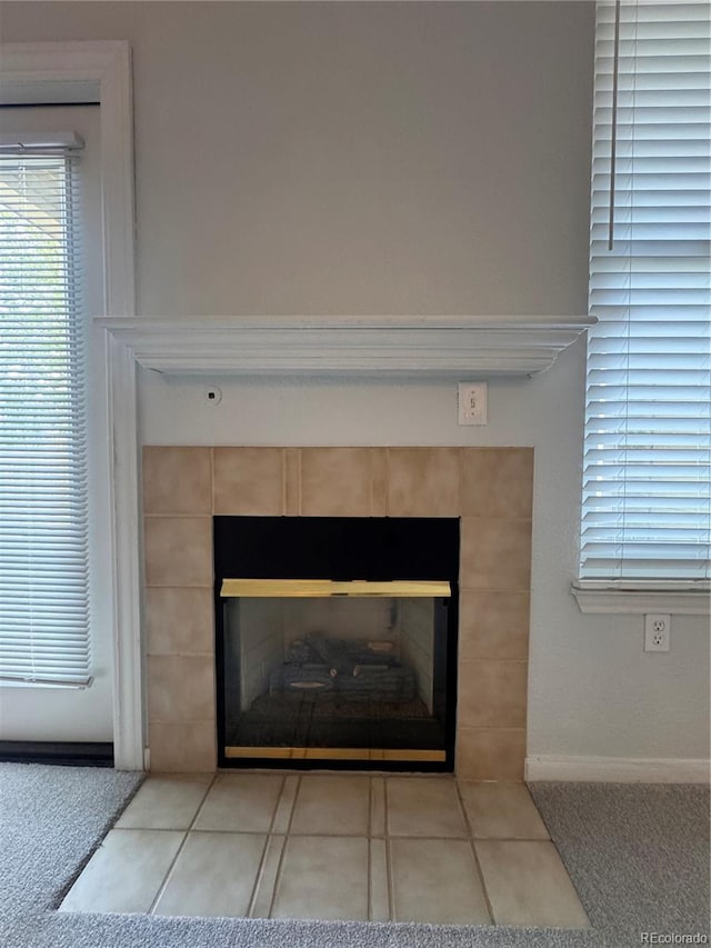 room details featuring a tile fireplace