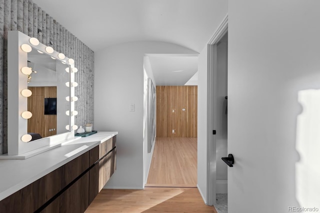 bathroom featuring baseboards, wood finished floors, and vanity