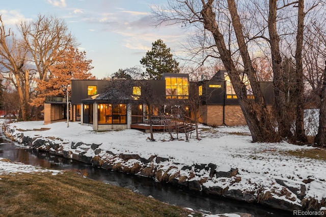 view of snow covered rear of property