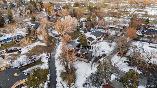 snowy aerial view with a residential view