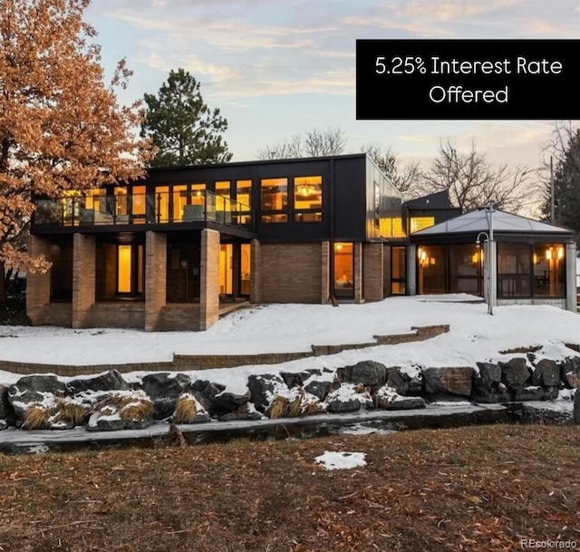 snow covered property featuring a garage