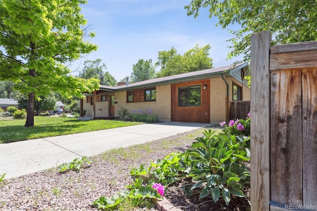 2901 Lorraine Ct, Boulder, CO 80304 - ranch-style home with brick siding, a front lawn, and a chimney