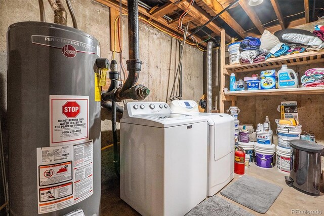 clothes washing area with gas water heater and washer and dryer