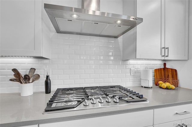 8839 Culebra St, Arvada, CO 80007 - kitchen with exhaust hood, stainless steel gas stovetop, light countertops, and backsplash