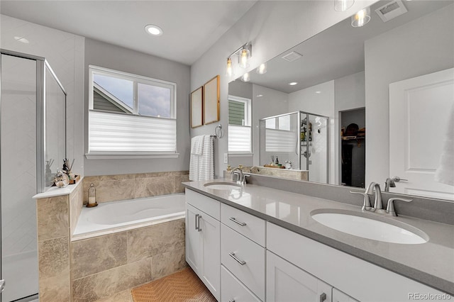 8839 Culebra St, Arvada, CO 80007 - bathroom with a stall shower, double vanity, a garden tub, a walk in closet, and tile patterned floors
