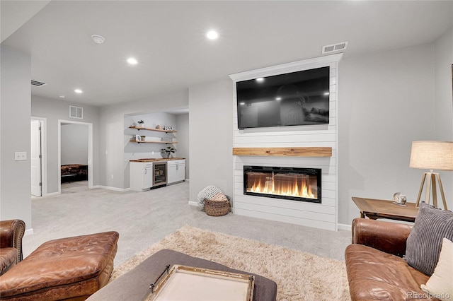 8839 Culebra St, Arvada, CO 80007 - living area with carpet flooring, beverage cooler, a large fireplace, and recessed lighting