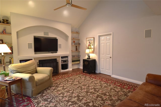 living room with high vaulted ceiling, built in features, and ceiling fan