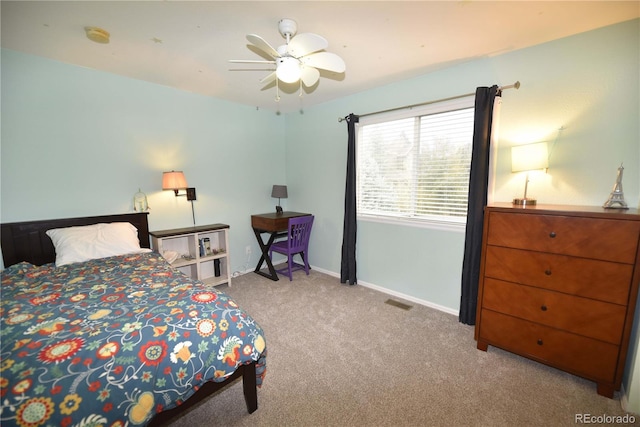 bedroom with ceiling fan and light carpet