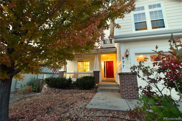 view of exterior entry with a porch