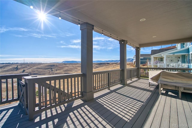 wooden deck with a mountain view