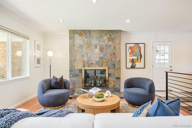 3025 S Norman Ct, Denver, CO 80224 - living room with crown molding, wood finished floors, recessed lighting, and a tiled fireplace