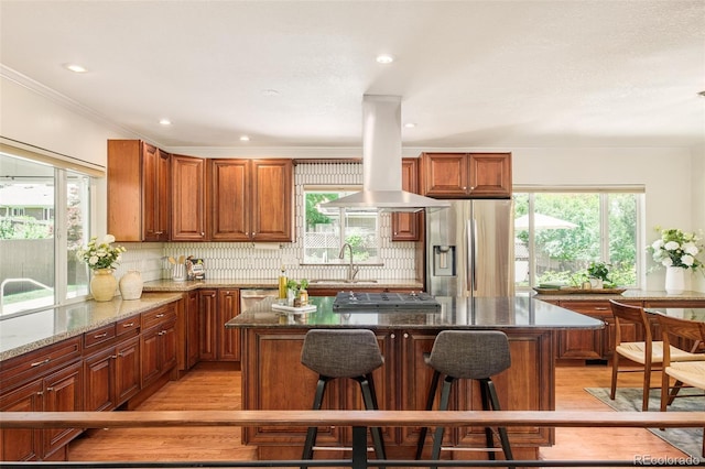 3025 S Norman Ct, Denver, CO 80224 - kitchen with appliances with stainless steel finishes, light wood finished floors, healthy amount of natural light, crown molding, and recessed lighting