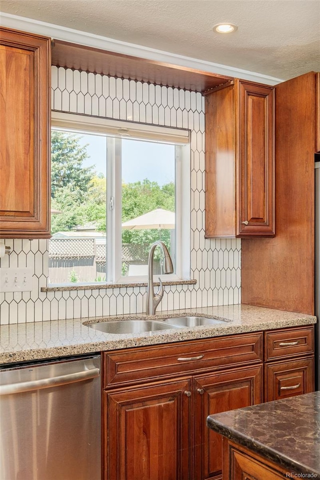 3025 S Norman Ct, Denver, CO 80224 - kitchen with stainless steel dishwasher, decorative backsplash, healthy amount of natural light, and brown cabinetry