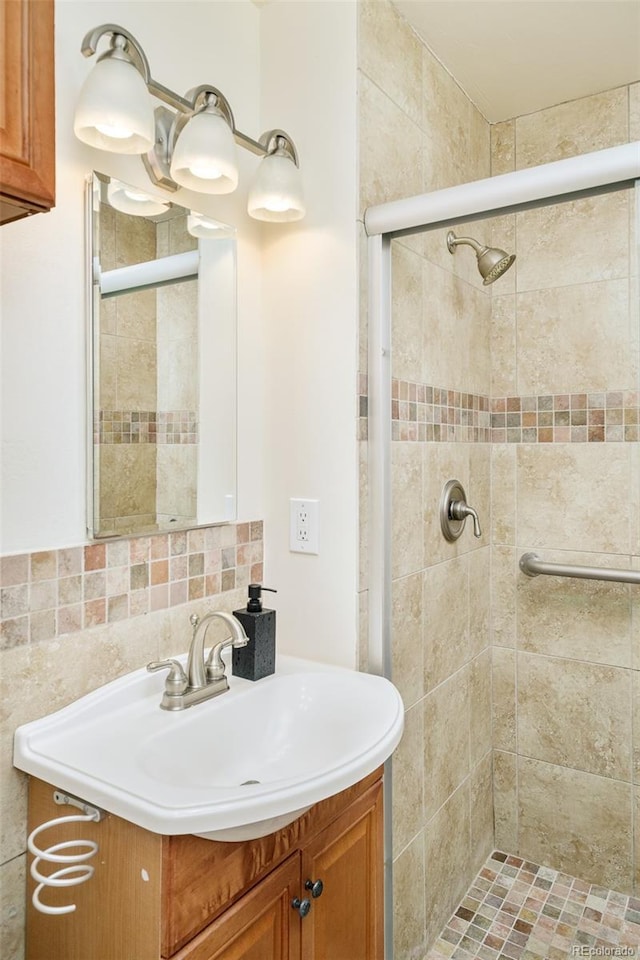 3025 S Norman Ct, Denver, CO 80224 - full bathroom featuring vanity, a stall shower, and tasteful backsplash