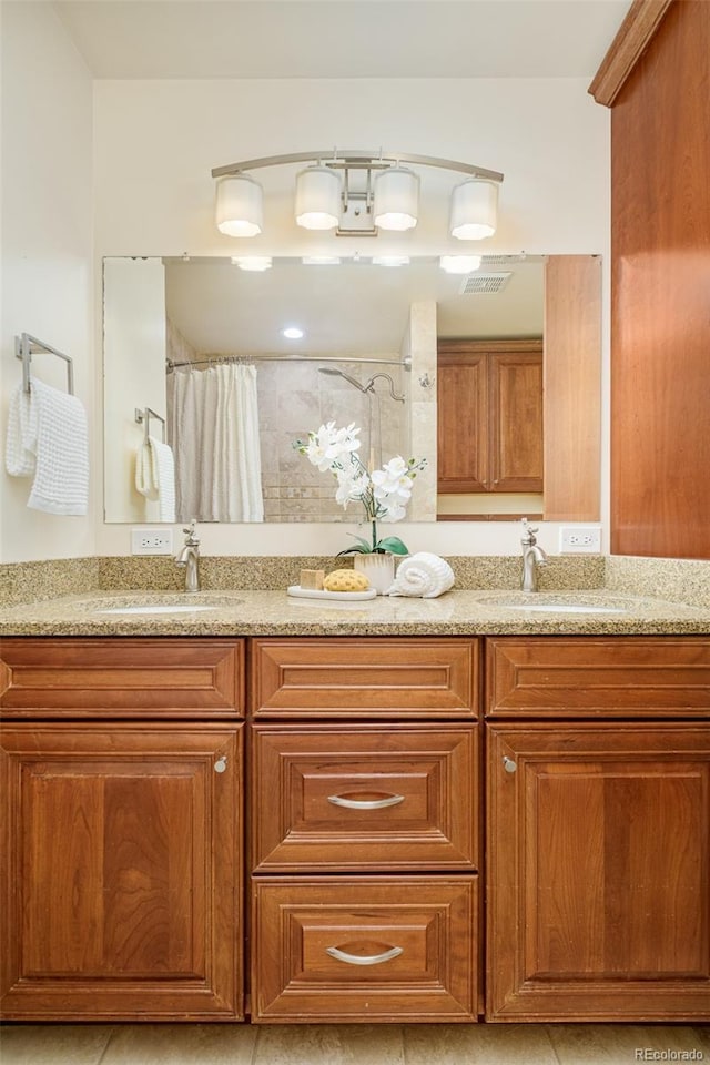 3025 S Norman Ct, Denver, CO 80224 - bathroom featuring double vanity and curtained shower