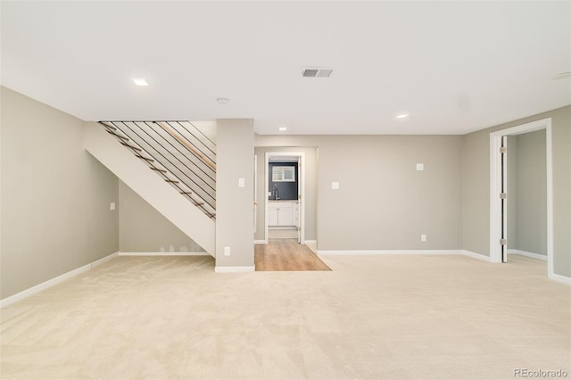 3025 S Norman Ct, Denver, CO 80224 - unfurnished living room featuring stairway, light carpet, and recessed lighting