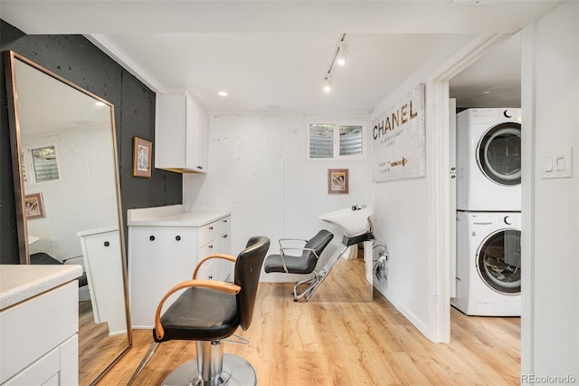 3025 S Norman Ct, Denver, CO 80224 - laundry room with stacked washer and clothes dryer and light wood-type flooring
