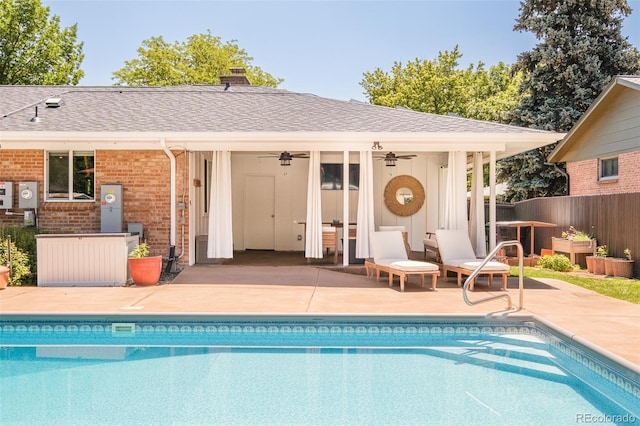 3025 S Norman Ct, Denver, CO 80224 - back of house featuring a storage structure, an outbuilding, brick siding, a patio, and an outdoor pool