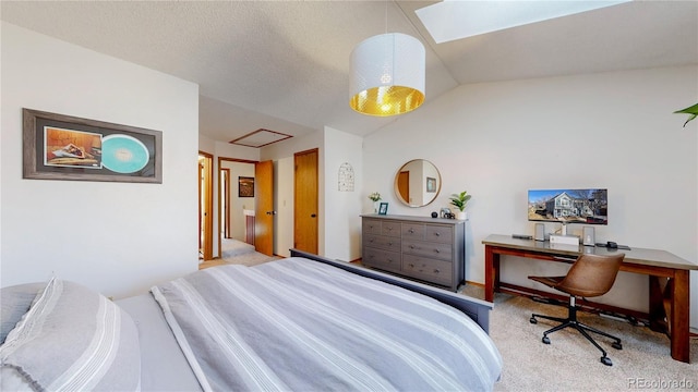 carpeted bedroom with vaulted ceiling with skylight and a textured ceiling