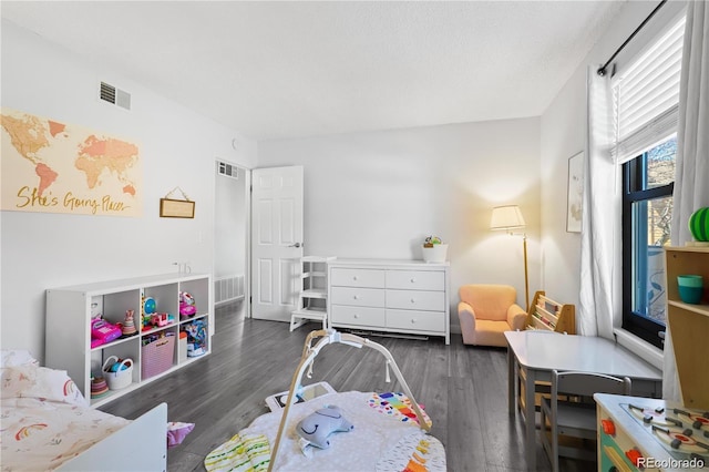 bedroom with wood finished floors and visible vents