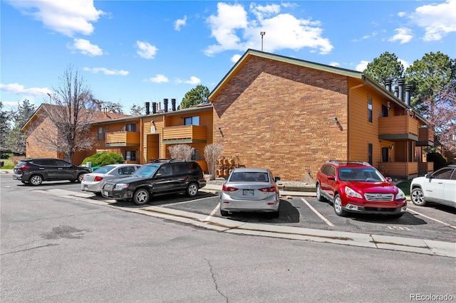 view of property featuring uncovered parking