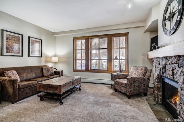 carpeted living room featuring a baseboard radiator and a stone fireplace