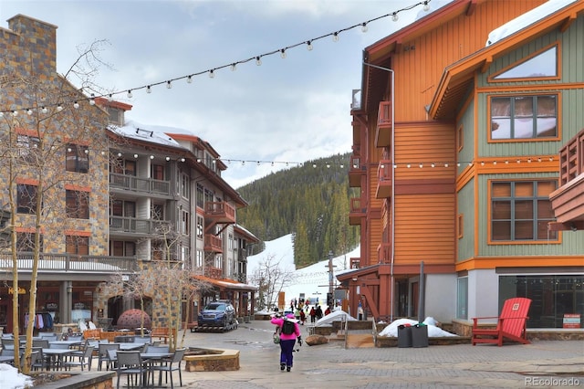 snow covered building featuring a mountain view