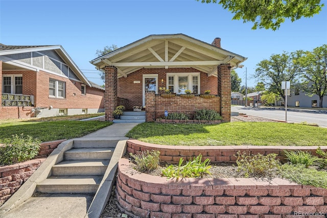 view of front of home with a front lawn and a porch