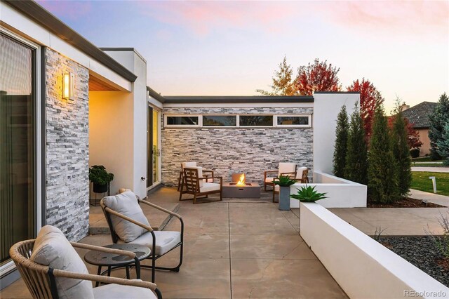 view of patio with an outdoor fire pit