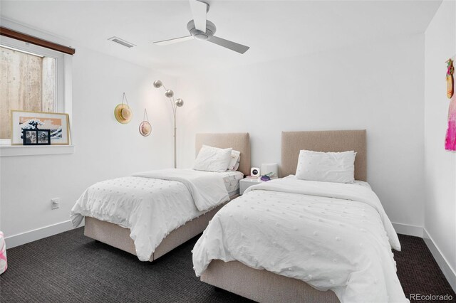 carpeted bedroom featuring a ceiling fan, baseboards, and visible vents