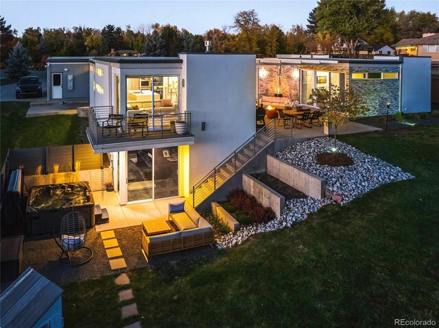 back of house with a patio, stucco siding, and a yard