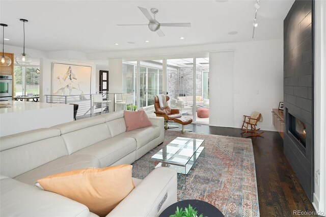 living area featuring recessed lighting, ceiling fan, and dark wood finished floors