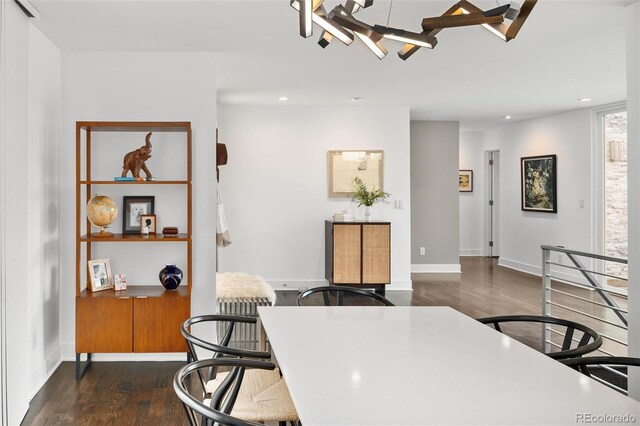 dining room featuring recessed lighting, baseboards, an inviting chandelier, and dark wood-type flooring