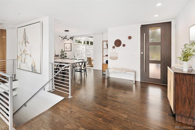 entryway with recessed lighting, stairs, and wood finished floors