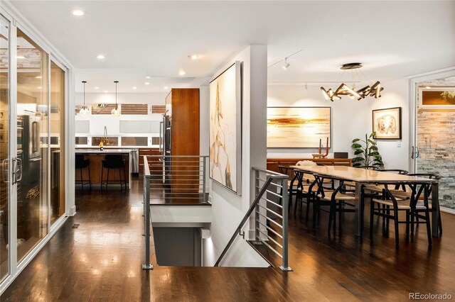 dining room with an inviting chandelier, recessed lighting, and dark wood-style floors