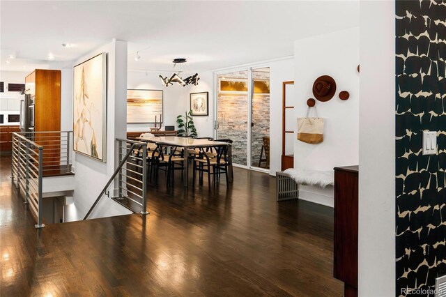 dining space with dark wood-style flooring