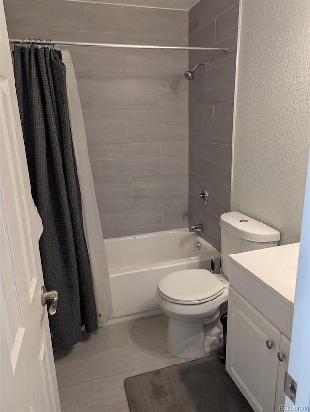 2870 S Ursula St, Aurora, CO 80014 - bathroom featuring toilet, a textured wall, shower / bath combo, and vanity