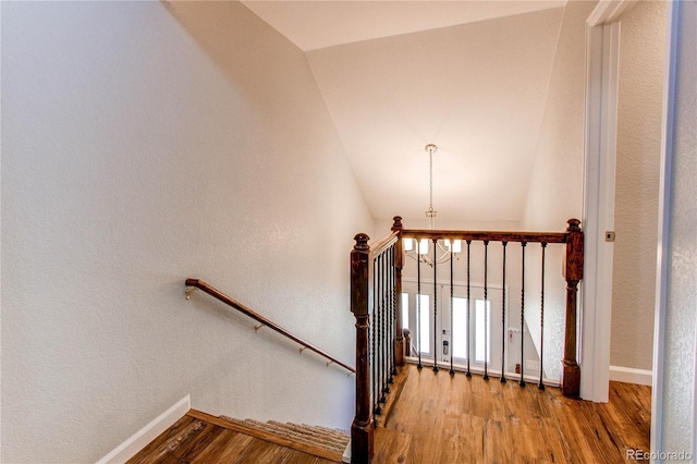 2870 S Ursula St, Aurora, CO 80014 - stairway with a chandelier, baseboards, vaulted ceiling, and wood finished floors