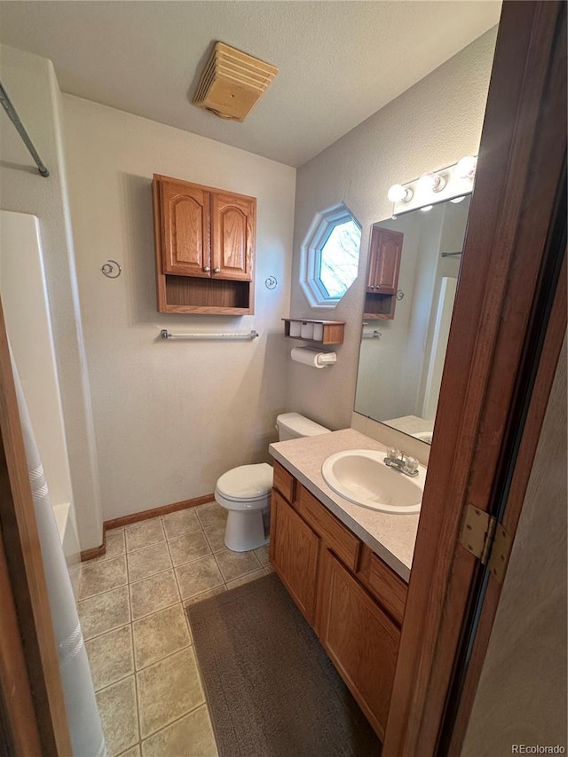 374 Krypton Ct, Loveland, CO 80537 - full bathroom with toilet, vanity, tile patterned floors, and baseboards