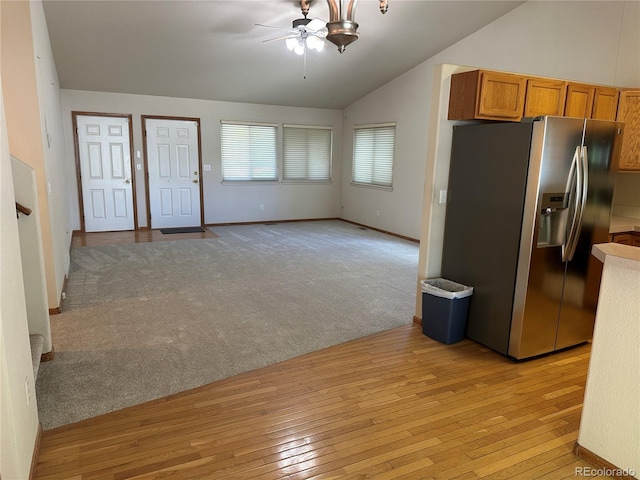 374 Krypton Ct, Loveland, CO 80537 - kitchen featuring stainless steel fridge with ice dispenser, a ceiling fan, lofted ceiling, brown cabinets, and light wood-type flooring