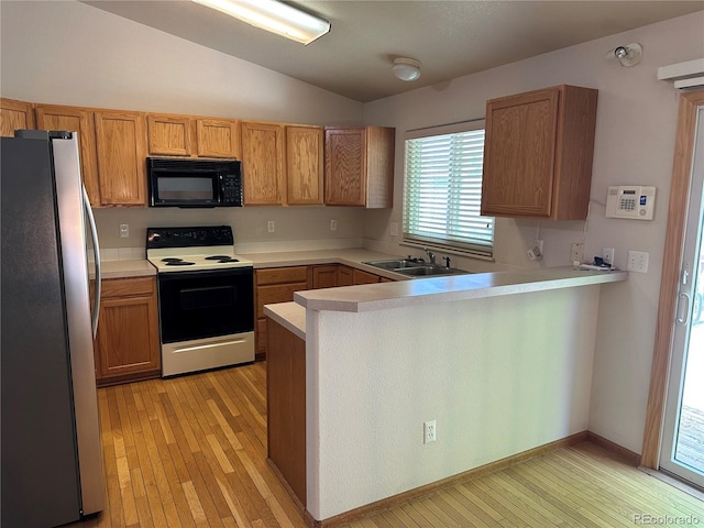374 Krypton Ct, Loveland, CO 80537 - kitchen with freestanding refrigerator, black microwave, range with electric stovetop, a sink, and lofted ceiling