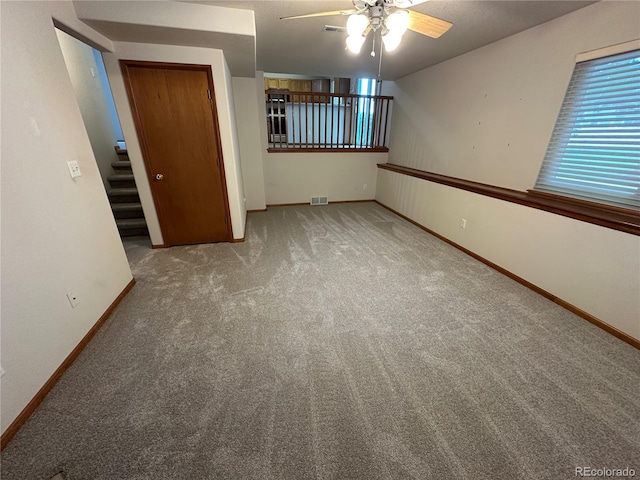 374 Krypton Ct, Loveland, CO 80537 - carpeted empty room featuring ceiling fan, baseboards, and stairs