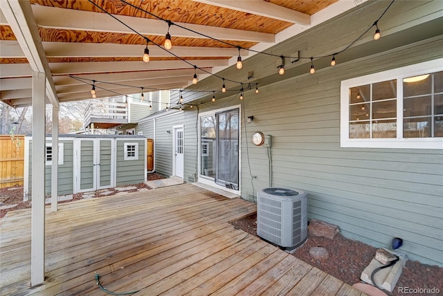 wooden terrace featuring cooling unit and an outdoor structure