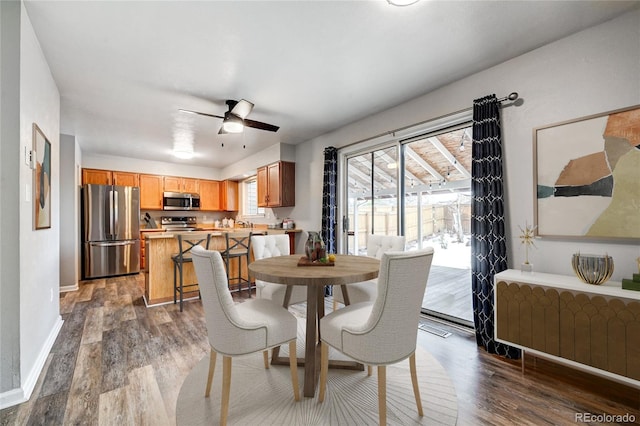 dining area featuring ceiling fan, dark hardwood / wood-style flooring, and radiator heating unit