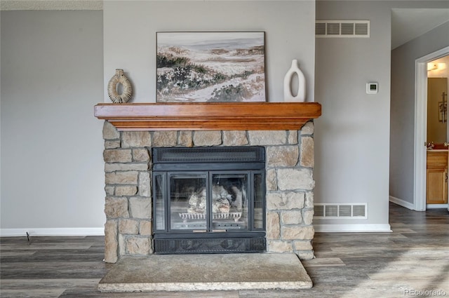 details with a stone fireplace and hardwood / wood-style floors