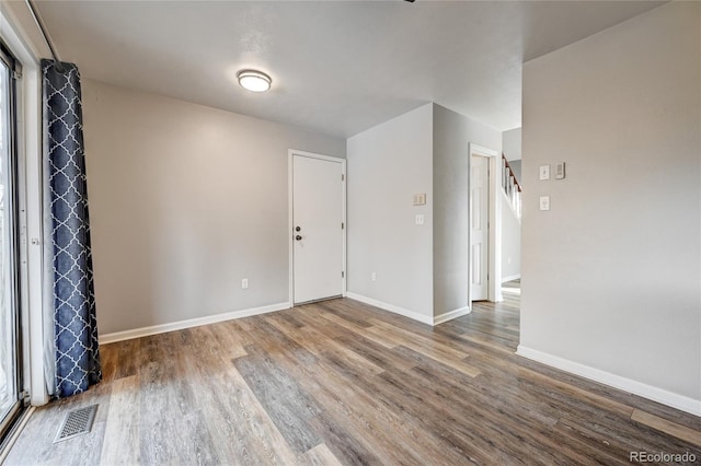 empty room with hardwood / wood-style floors