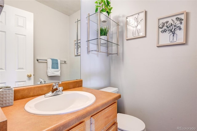 bathroom featuring toilet and vanity