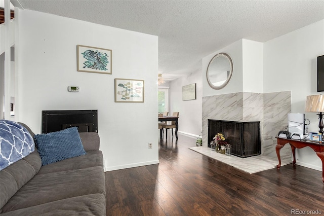 1977 S Oakland Way, Aurora, CO 80014 - living room featuring wood finished floors, a premium fireplace, ceiling fan, and a textured ceiling