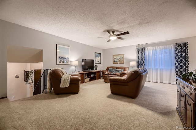 living area with a ceiling fan, carpet, a textured ceiling, and a wealth of natural light